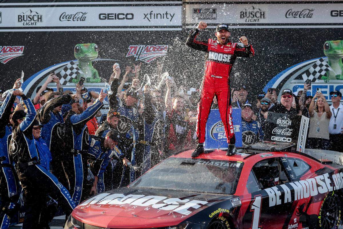 Ross Chastain, top, celebrates his win in Victory Lane after a NASCAR Cup Series auto race Sunday, April 24, 2022, in Talladega, Ala. (AP Photo/Butch Dill)