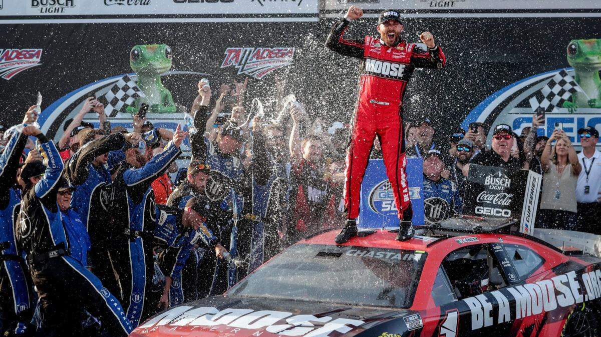 Ross Chastain, top, celebrates his win in Victory Lane after a NASCAR Cup Series auto race Sunday, April 24, 2022, in Talladega, Ala. (AP Photo/Butch Dill)