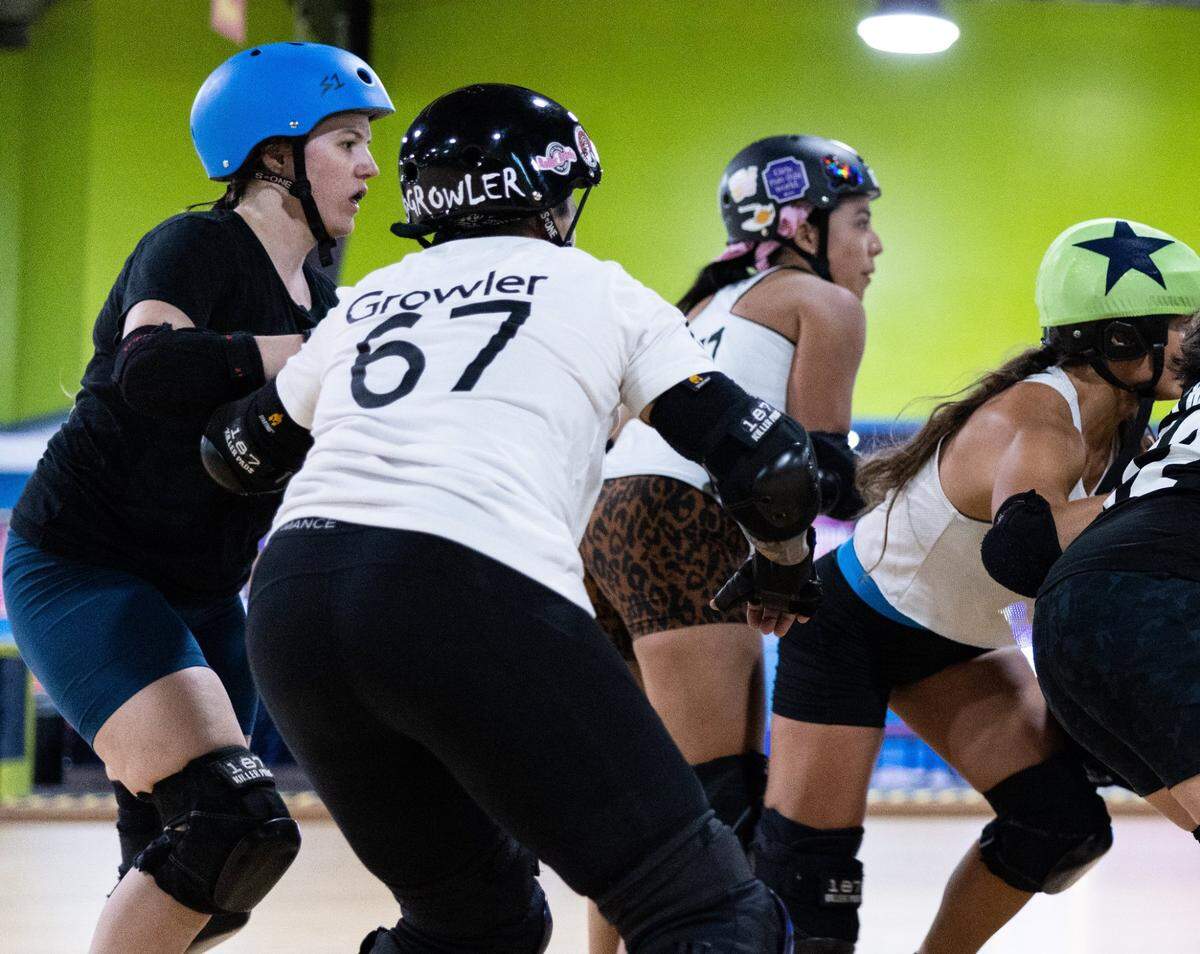 Amber “Nerd” Williams, left, blocks during a jam at Charlotte Roller Derby practice at Kate’s Skating Rink on July 30, 2023.
