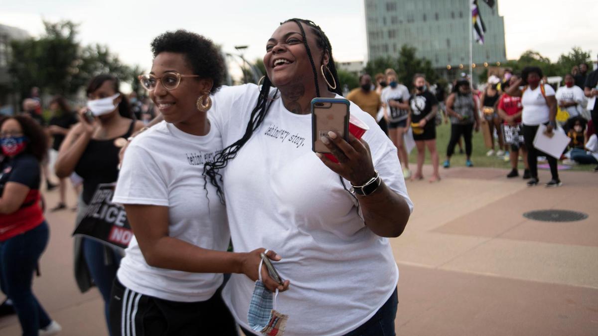 At left, Keiosha Jordan, 24, of Charlotte, head of the nonprofit Behind Every Story, greets Lauree Castro, 25, of the Bronx after she recited a self-written poem at Friday’s Juneteenth rally in Charlotte.