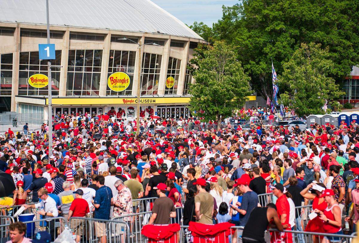Crowds stand outside while former President Donald Trump begins to speak at the Bojangles Coliseum in Charlotte on July 24, 2024. Many people were still just coming in as Trump began speaking.