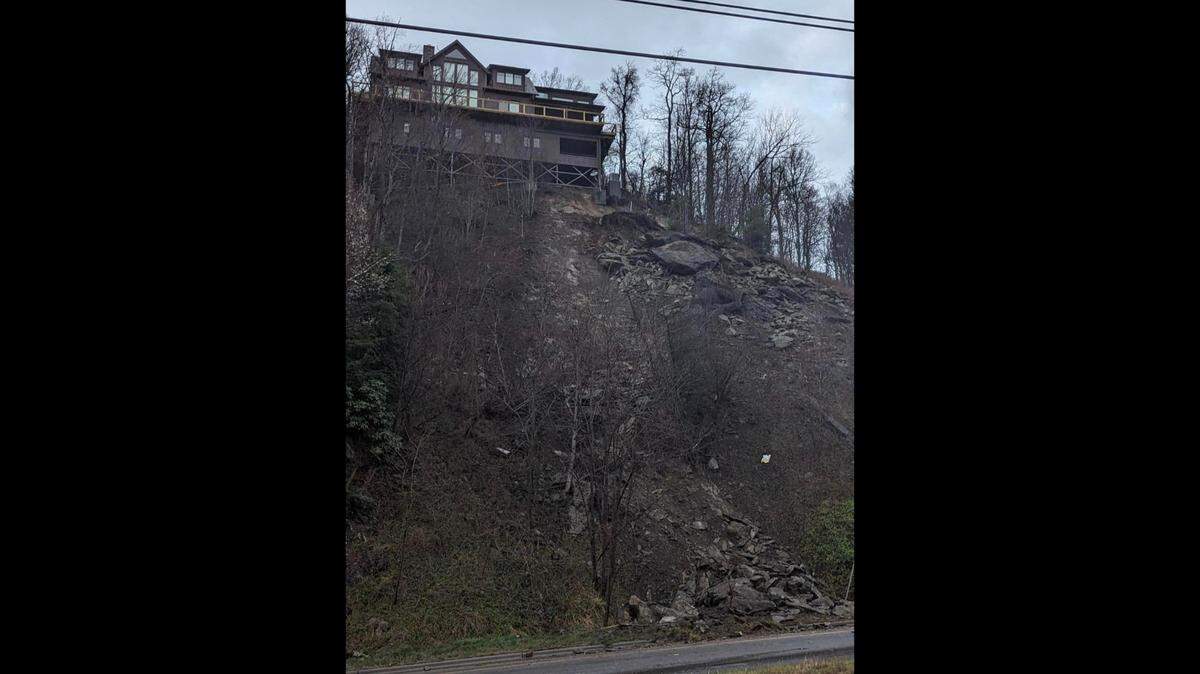 A rock slide during severe storms has closed a main highway to Blowing Rock, the popular tourist town in the N.C. mountains. Above the slide is a house.