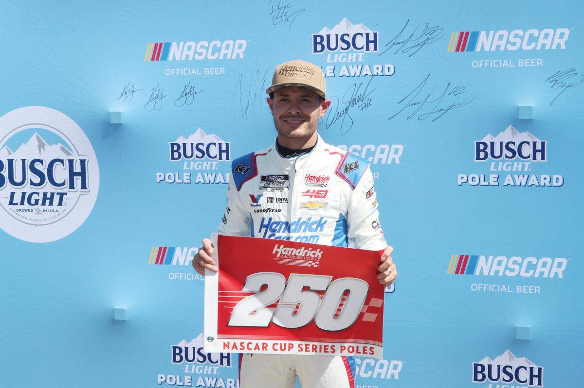 Apr 13, 2024; Fort Worth, Texas, USA; NASCAR Cup Series driver Kyle Larson (5) celebrates Hendrick Motor Sports 250th NASCAR Cup Series pole after qualifying for the NASCAR Cup Series AutoTrader EchoPark Automotive 400 at Texas Motor Speedway.