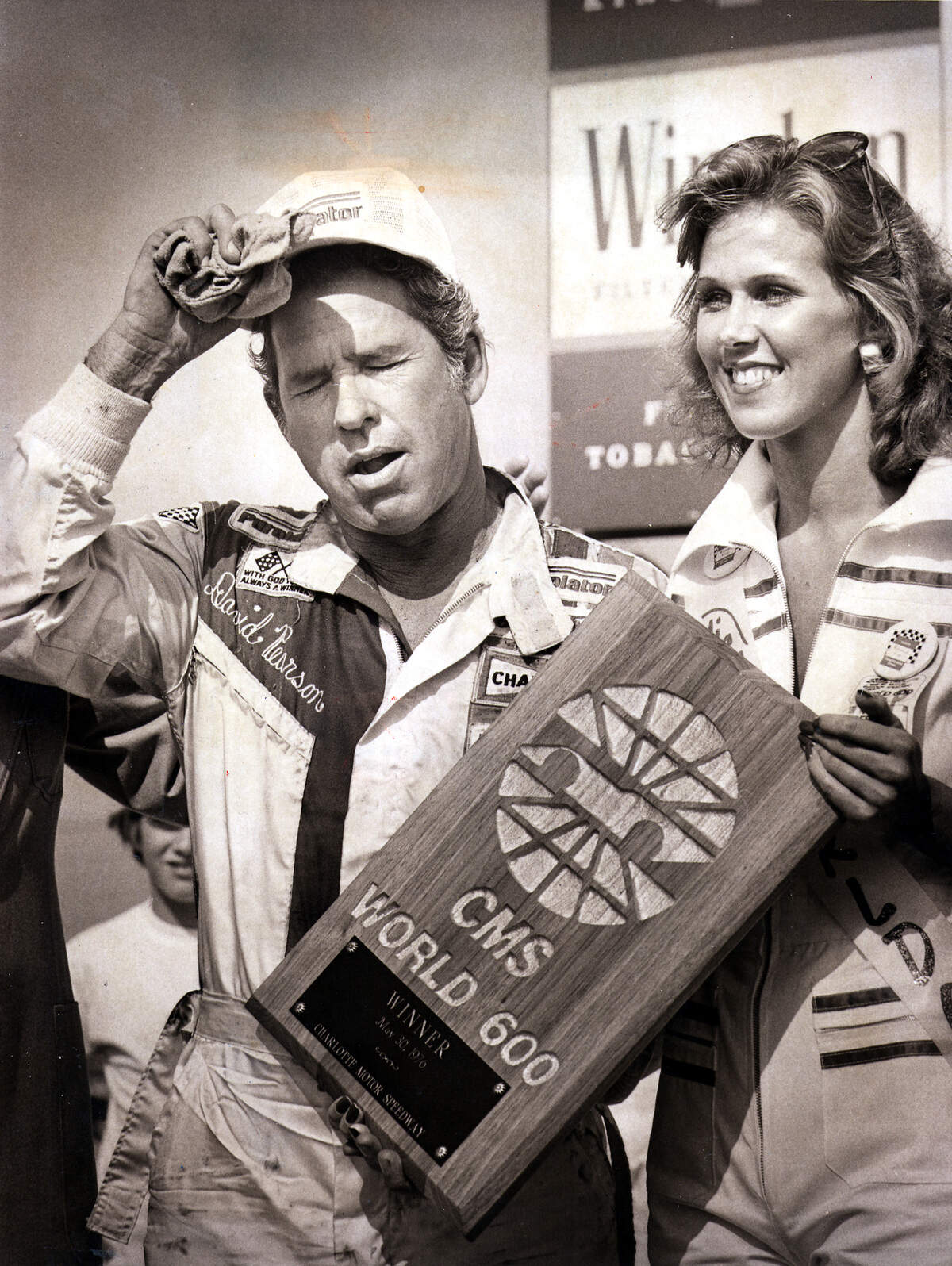 David Pearson catches his breath after winning the World 600 at Charlotte Motor Speedway in 1976. Pearson, a member of the NASCAR Hall of Fame, died at age 83 Monday.