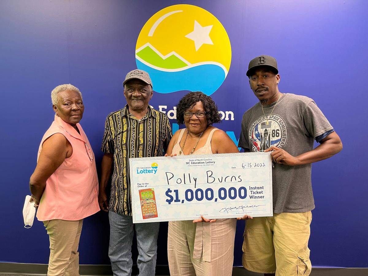 Polly Burns, 72, of Polkton holds her winning million dollar 50X The Cash scratch-off ticket. She took home $426,063 after taxes.