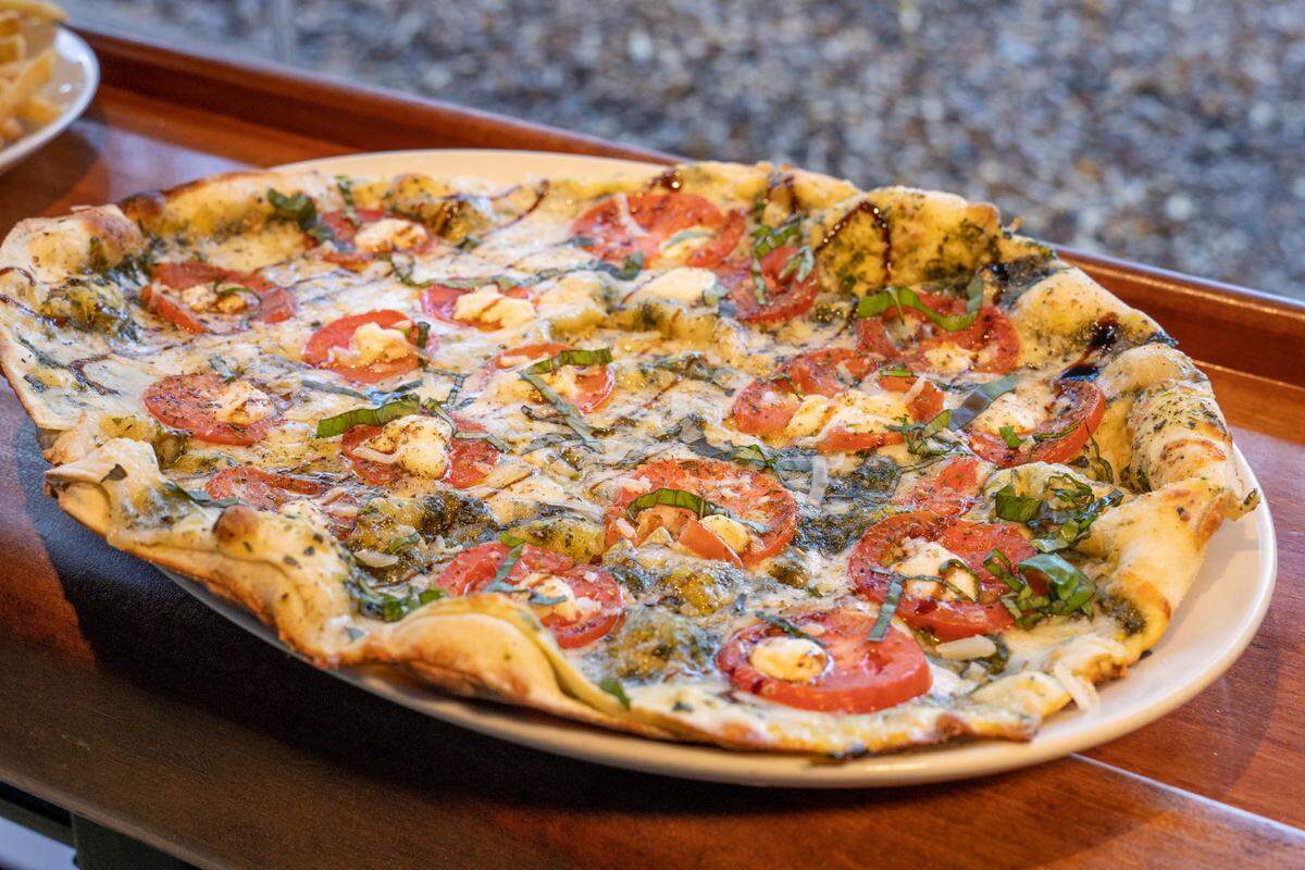 Harper’s Pizza Margherita has a basil pesto and garlic puree, marinated roma tomates, mozzarella and a balsamic drizzle.