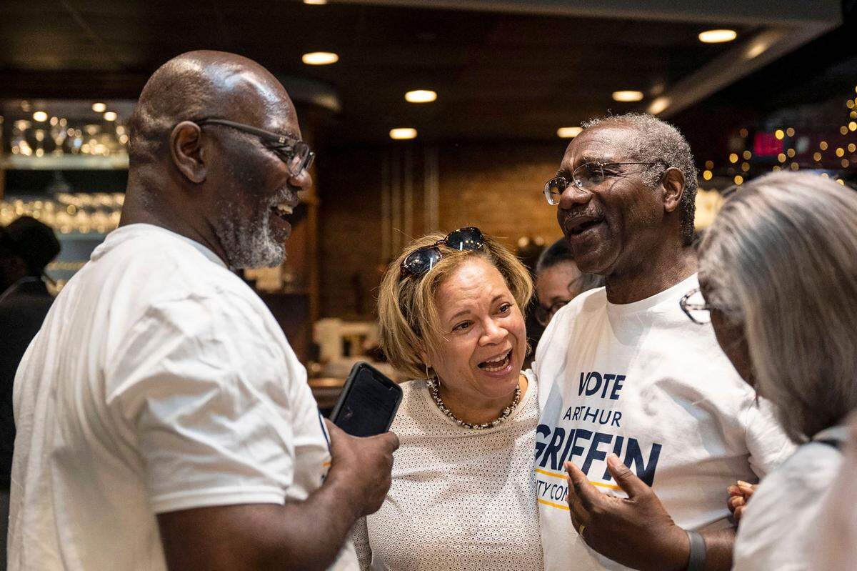 Charlotte’s Democratic incumbent mayoral candidate, Vi Lyles, second from left, speaks with George Dunlap, far left, Arthur Griffin and Dr. Wilhelmenia Rembert at the Black Political Caucus’ watch party at Studio 229 on Tuesday, May 17, 2022 in Charlotte.