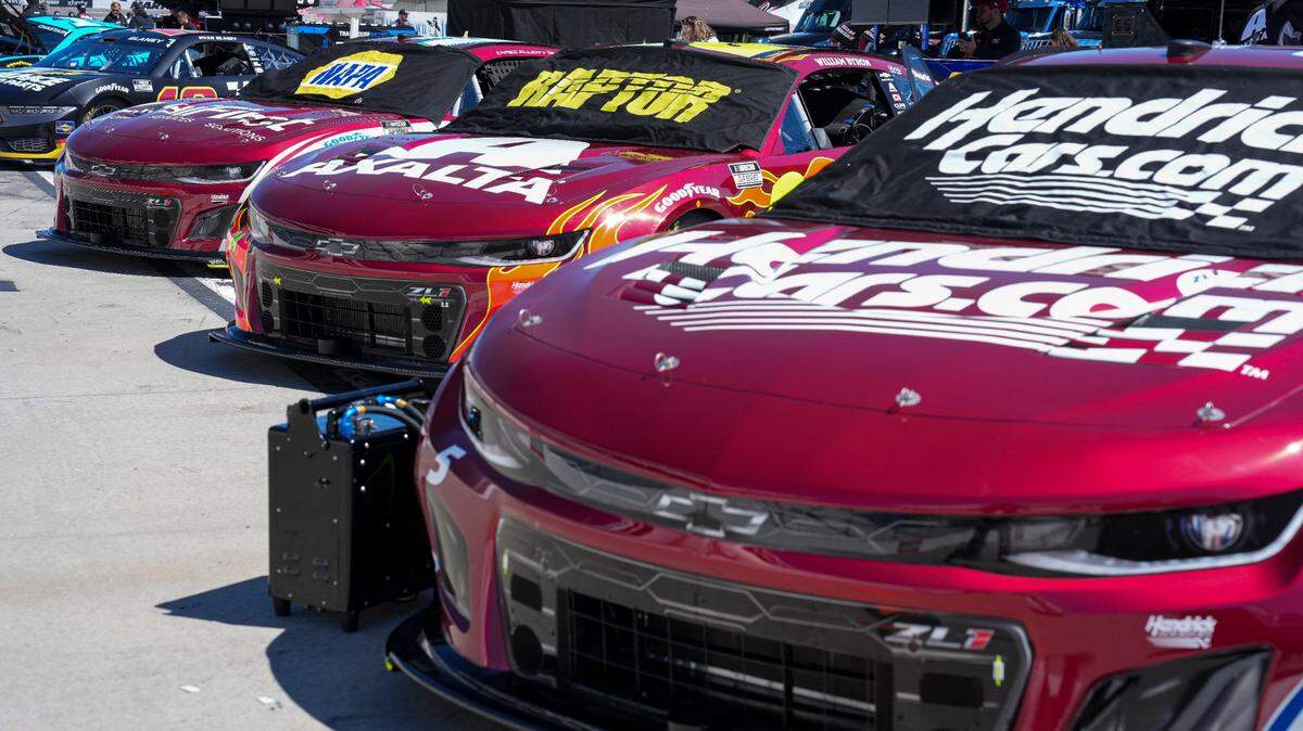 Apr 6, 2024; Martinsville, Virginia, USA; The cars of NASCAR Cup Series driver Kyle Larson (5), driver William Byron (24), driver Chase Elliott (9) painted with burgundy hoods to honor Hendrick Motorsports 40th Anniversary before practice at Martinsville Speedway.
