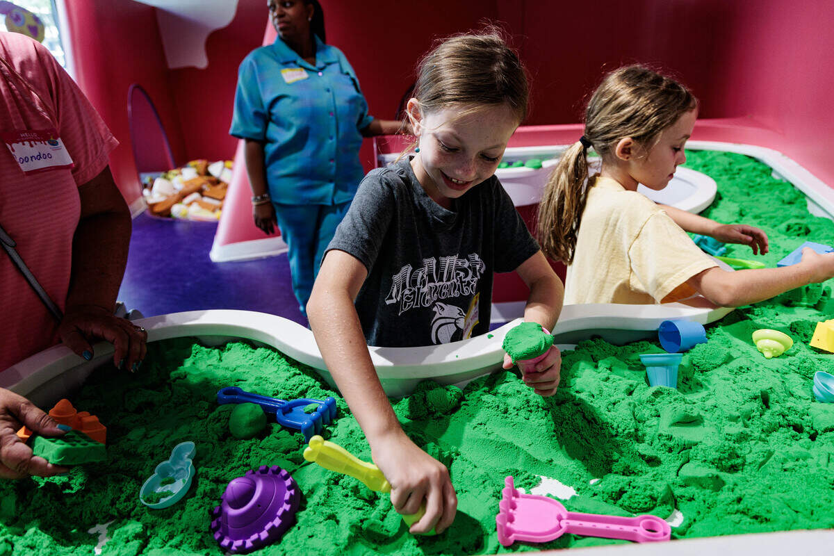 RaeLynne Samuelson, 9, plays in the sandbox-themed slime at the Sloomoo Institute on Wednesday, June 8, 2026.