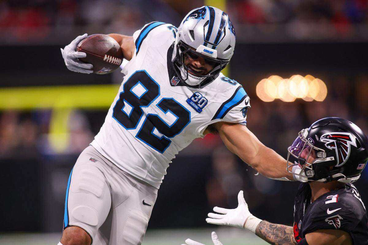Jan 5, 2025; Atlanta, Georgia, USA; Carolina Panthers tight end Tommy Tremble (82) is pushed out of bounds by Atlanta Falcons safety Jessie Bates III (3) in overtime at Mercedes-Benz Stadium. Mandatory Credit: Brett Davis-Imagn Images