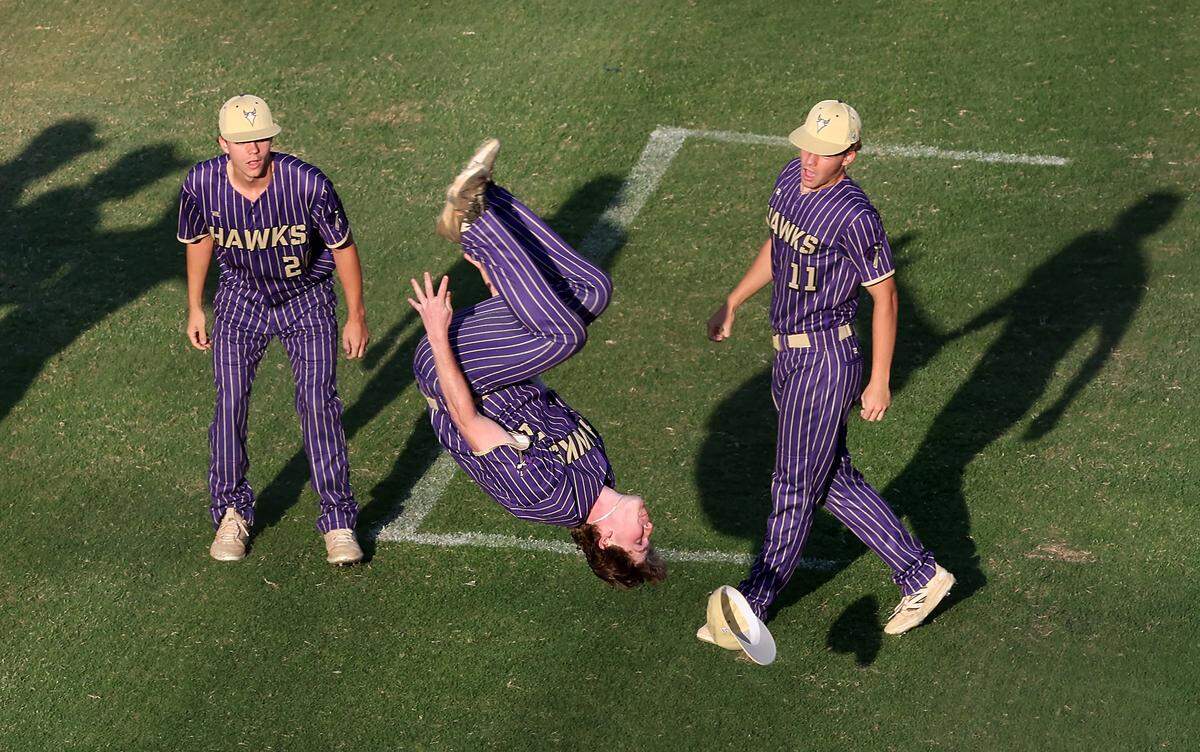 Holly Springs Hawks’ outfielder Brandon Goss, center, does a backflip after a 3-1 victory over the Marvin Ridge Mavericks in Game 1 of the NCHSAA 7A Baseball Championship at the Burlington Athletic Stadium on  May 29, 2026, in Burlington. The Wake County school system is hoping to increase marketing deals to raise more money for its athletic program.