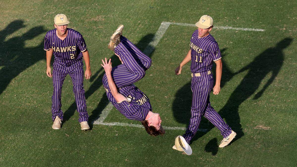 Holly Springs Hawks’ outfielder Brandon Goss, center, does a backflip after a 3-1 victory over the Marvin Ridge Mavericks in Game 1 of the NCHSAA 7A Baseball Championship at the Burlington Athletic Stadium on  May 29, 2026, in Burlington. The Wake County school system is hoping to increase marketing deals to raise more money for its athletic program.