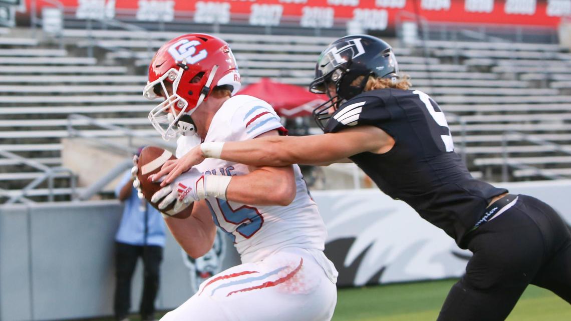 Charlotte Catholic tight end Jack Larsen (85) hauls in a touchdown pass over Havelock defender Anthony Granger(9) during the NCHSAA 3A State Championship football game between Charlotte Catholic and Havelock in Raleigh on Friday, May 7, 2021.