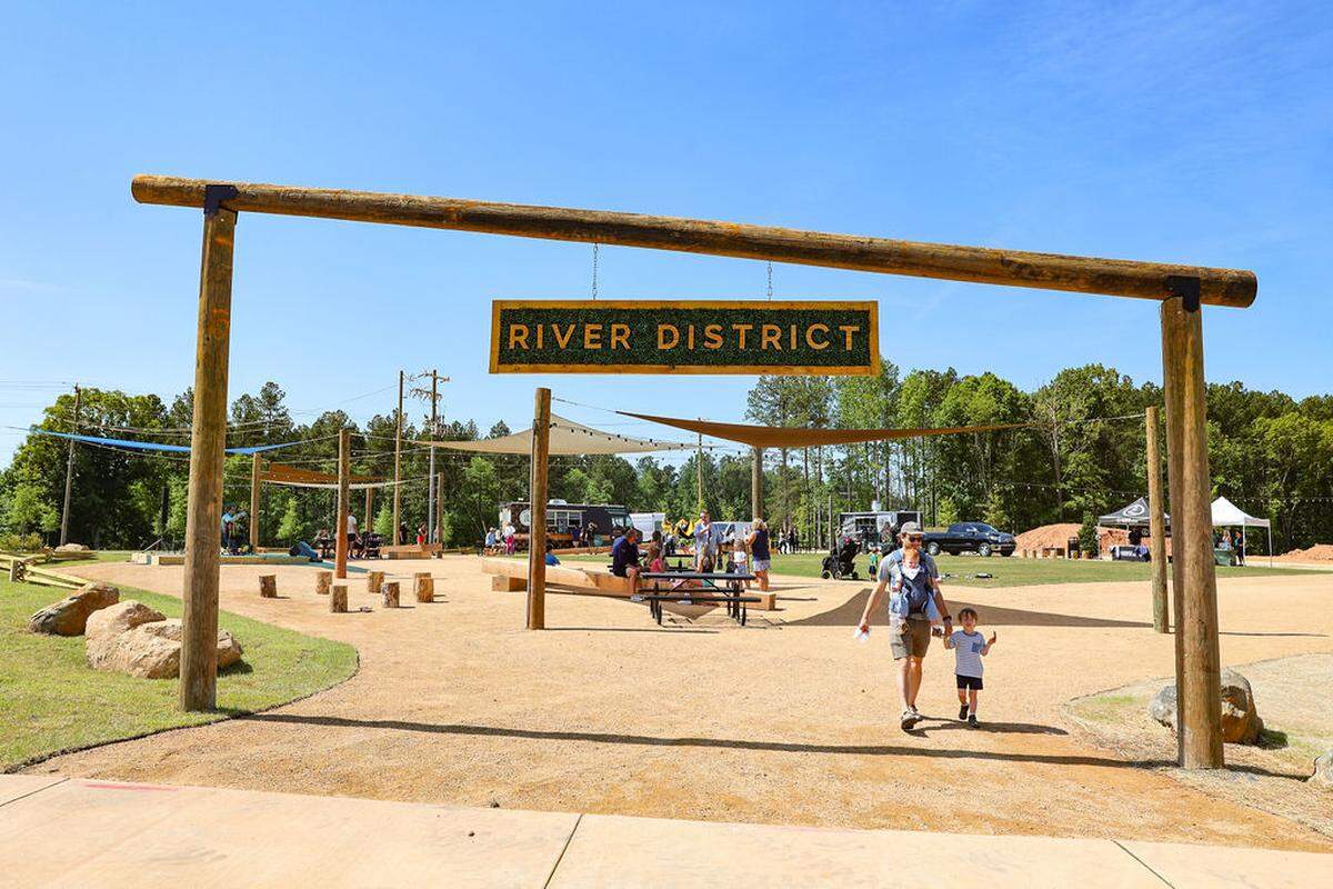 The River District in West Charlotte is continuing to take shape. New townhome rentals are on the horizon. Here, a segment of the three-mile Forge Village Trail Loop, a walking and bicycle path, opened in May.