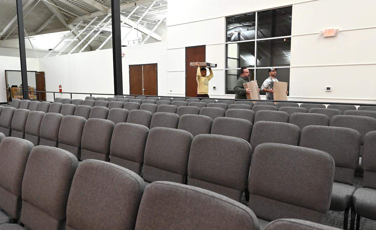Finishing touches are being shored up inside the Moments of Hope sanctuary on Thursday, April 14, 2022. Pastor David Chadwick and parishioners will be moving into the new church that was formerly a Harris Teeter grocery story and climbing gym located off Providence Road at Providence Square Shopping Center. The first service will be held on April 24, 2022.