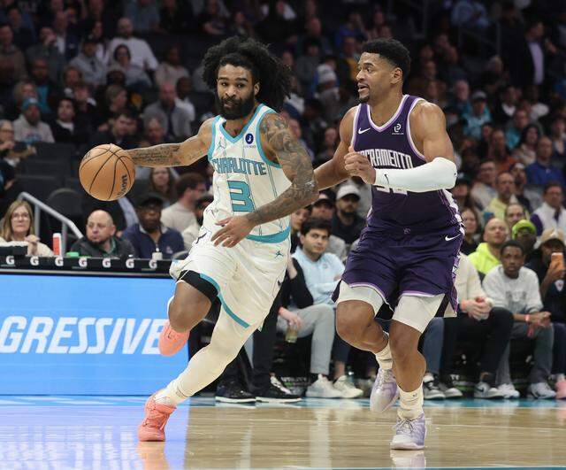Charlotte Hornets guard Coby White drives past Sacramento Kings center Dyland Cardwell during the game Tuesday, March 24, 2026 at Spectrum Center in Charlotte.