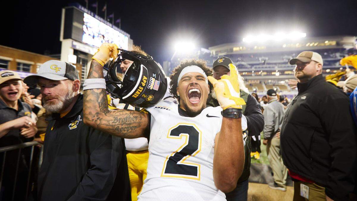 Kaedin Robinson celebrates after scoring the game-winning touchdown in overtime in Appalachian State’s 26-23 upset victory over James Madison in 2023. Robinson, from Asheville, wasn’t able to get in contact with his family for several days after Hurricane Helene.