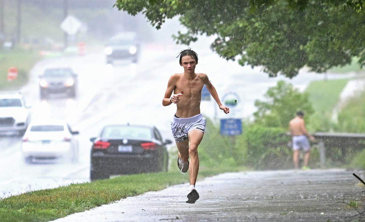 Cade Cresswell runs under the rain near Four Mile Creek Greenway in Matthews, N.C. on Thursday as Tropical Storm Debby hit. He is a cross country runner at Porter Ridge High School.