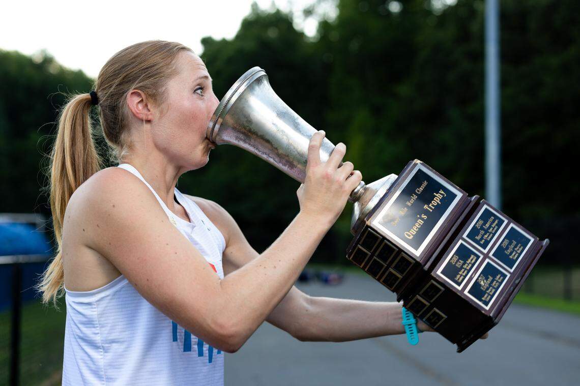 Elizabeth Laseter sips beer from the trophy she won at the 2023 Beer Mile World Classic in July.