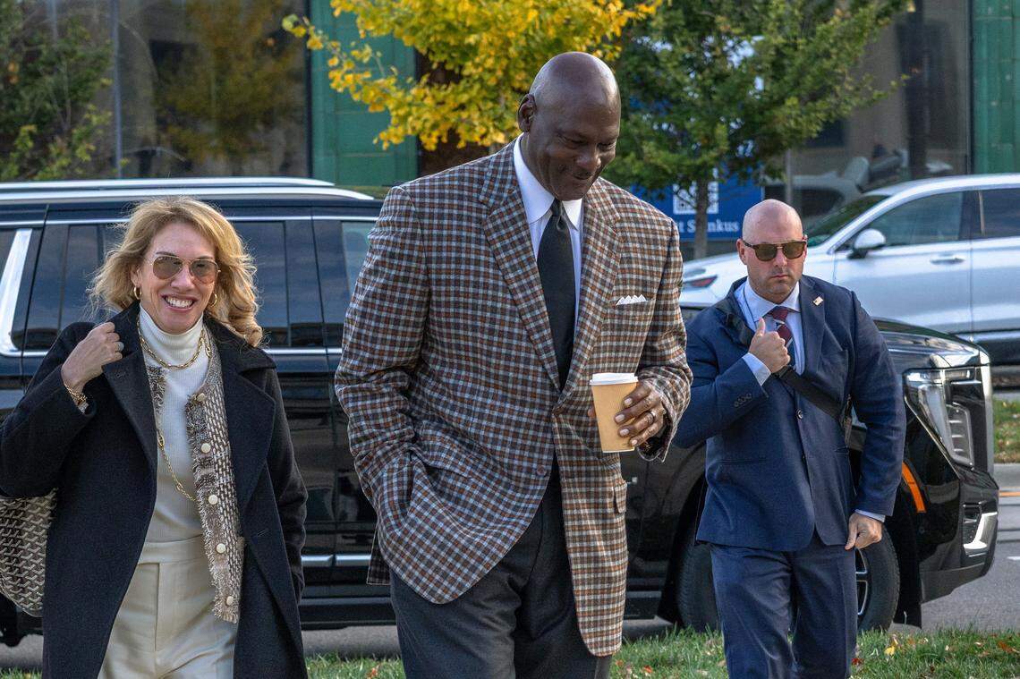 Michael Jordan (center), co-owner of 23XI Racing, arrives for trial at the Charles R Jonas Federal Building on December 1, 2025 in Charlotte.