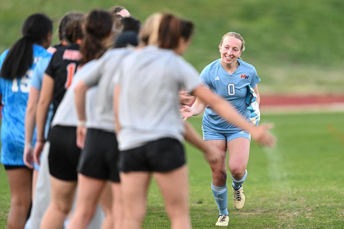 Marvin Ridge’s Molly Estes (0) high-fives teammates prior to a varsity soccer match against Providence Day, Tuesday, March 25, 2025, in Charlotte, N.C. (Charlotte Observer/Matt Kelley)