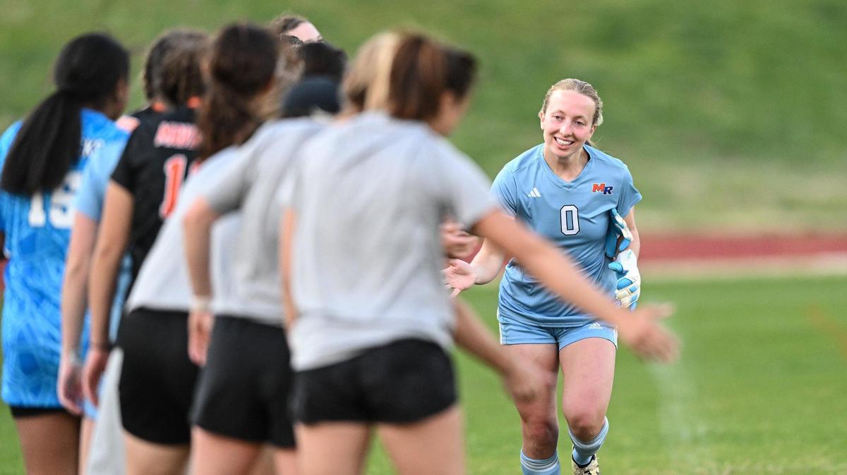 Marvin Ridge’s Molly Estes (0) high-fives teammates prior to a varsity soccer match against Providence Day, Tuesday, March 25, 2025, in Charlotte, N.C. (Charlotte Observer/Matt Kelley)