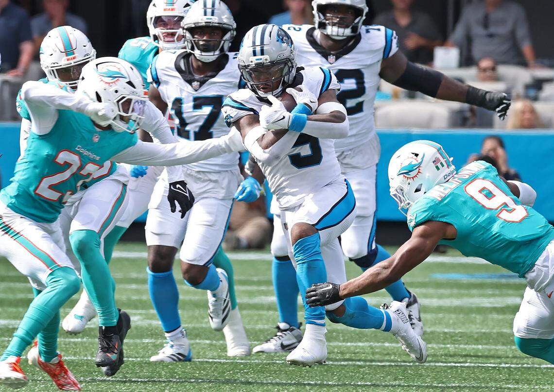 Carolina Panthers running back Rico Dowdle, center, breaks up the middle on a run against the Miami Dolphins on Sunday, October 5, 2025 at Bank of America Stadium in Charlotte, NC. The Panthers defeated the Dolphins 27-24.