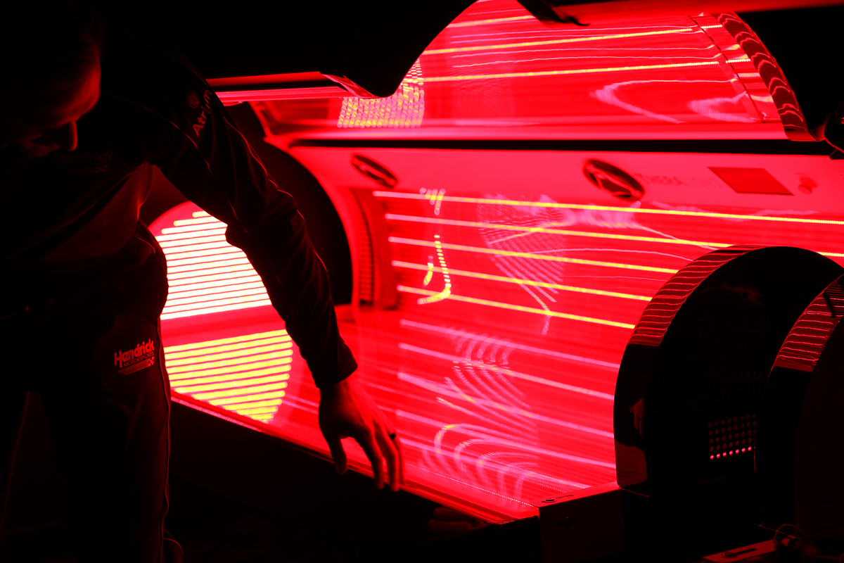 Matt Mauldin, assistant strength and conditioning coach, demonstrates the TheraLight 360i Red Light Therapy Bed at the new Atrium Health Motorsports Athletic Center.