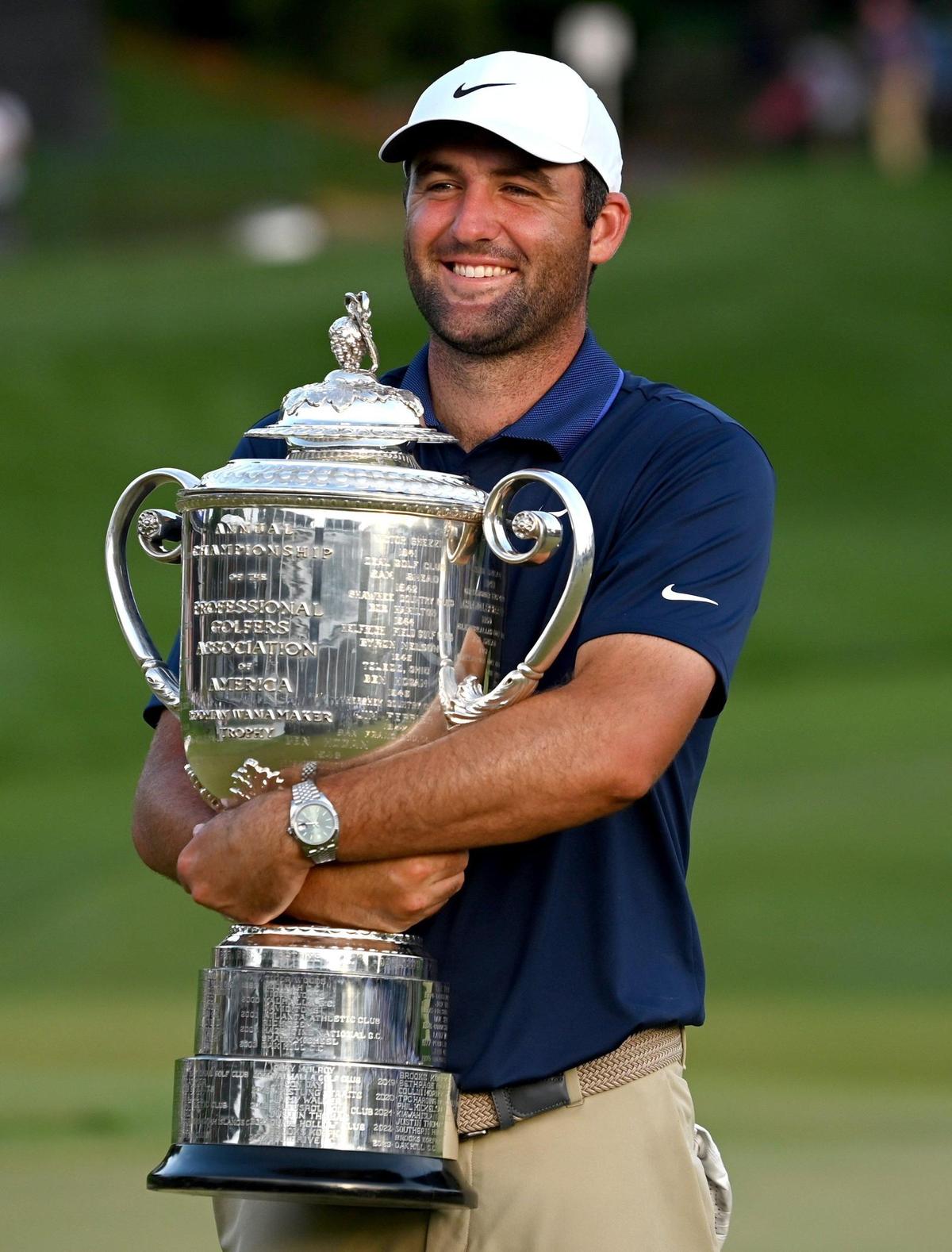 Scottie Scheffler hugs the Wanamaker Trophy after winning the PGA Championship at Quail Hollow Club in Charlotte, NC on Sunday, May 18, 2025. Scheffler shot -11 for the tournament.