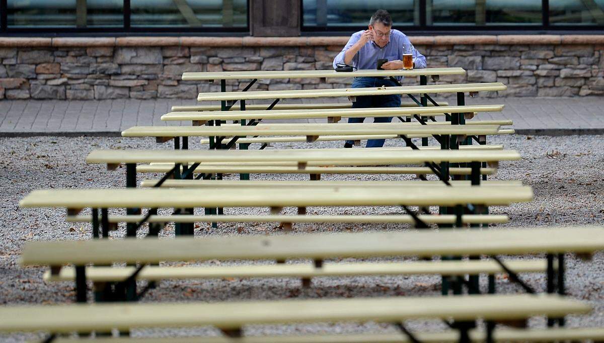A patron enjoys one of Olde Mecklenburg Brewery’s beverages in solitude at a picnic table on Monday, November 9, 2020.