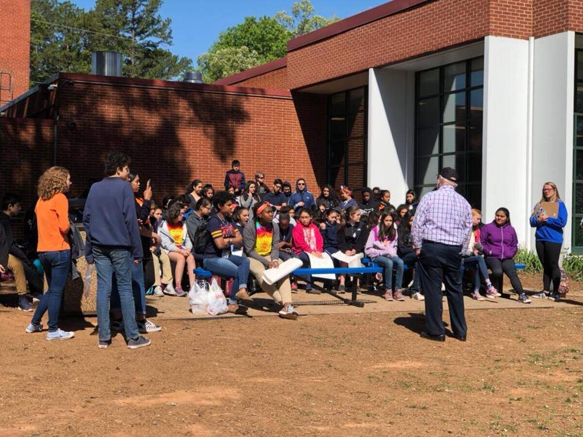 Collinswood Language Academy students listen to a Vietnam War veteran speak at an April 20 National School Walkout event.