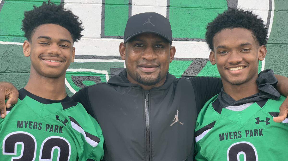 Former NFL cornerback Dre Bly, seen with his sons Jordan (left) and Trey, is one of seven parents on the Myers Park High roster with NFL ties.