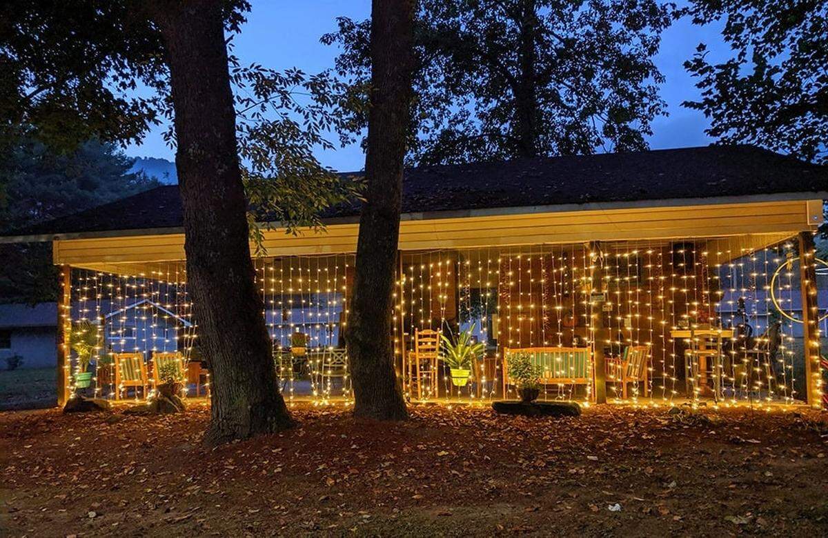 An evening photo of the “BackPorch Pavilion,” lit up for an event.