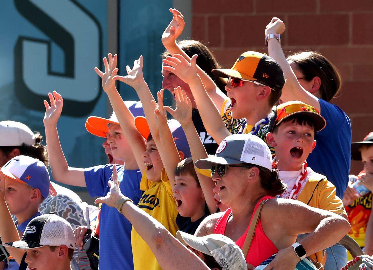 Fans cheer for members of the Firefighters to throw water balloons at them outside Truist Field in Charlotte, NC on Thursday, June 4, 2026. Fans were treated to Banana Ball action between the Texas Tailgaters and Firefighters.