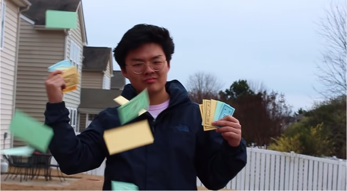 "Middle class America and I ain't got the bands (Cash)," Kim raps while throwing Monopoly money into the air.