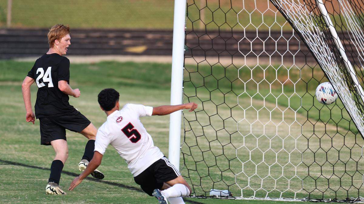 South Meck’s Jack Lambertson, left, scores a goal against as West Cabarrus’ Isidroh Garcia, right, attempts to stop the goal during prep boys soccer action on Monday, August 12, 2024.
