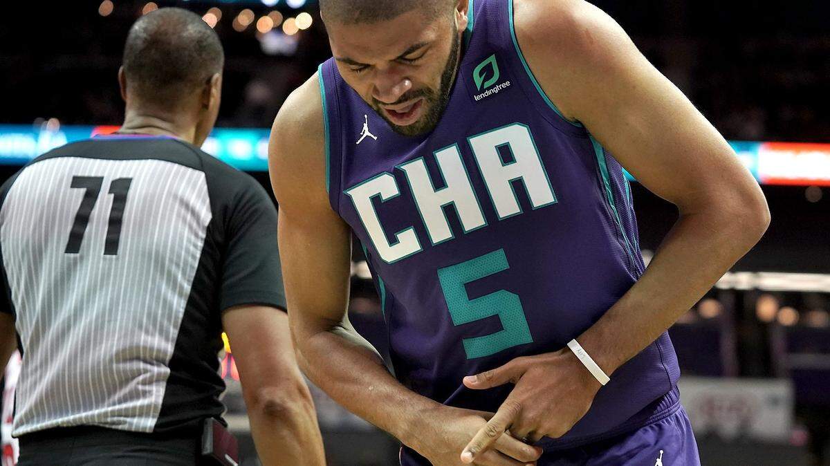 Charlotte Hornets guard Nicolas Batum holds onto the fingers on his left hand after being injured during second half action against the Chicago Bulls at Spectrum Center in Charlotte, NC on Wednesday, October 23, 2019. The Hornets defeated the Bulls 126-125.