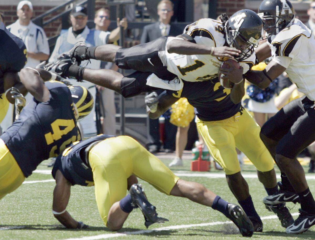 Appalachian State quarterback Armanti Edwards dives over Michigan linebackers for a touchdown in September 2007 in Ann Arbor, Michigan.