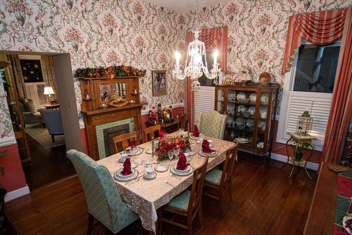 The dining room of the Fennimore Residence on 9th Street features a decorated mantle and a display of nutcrakers.