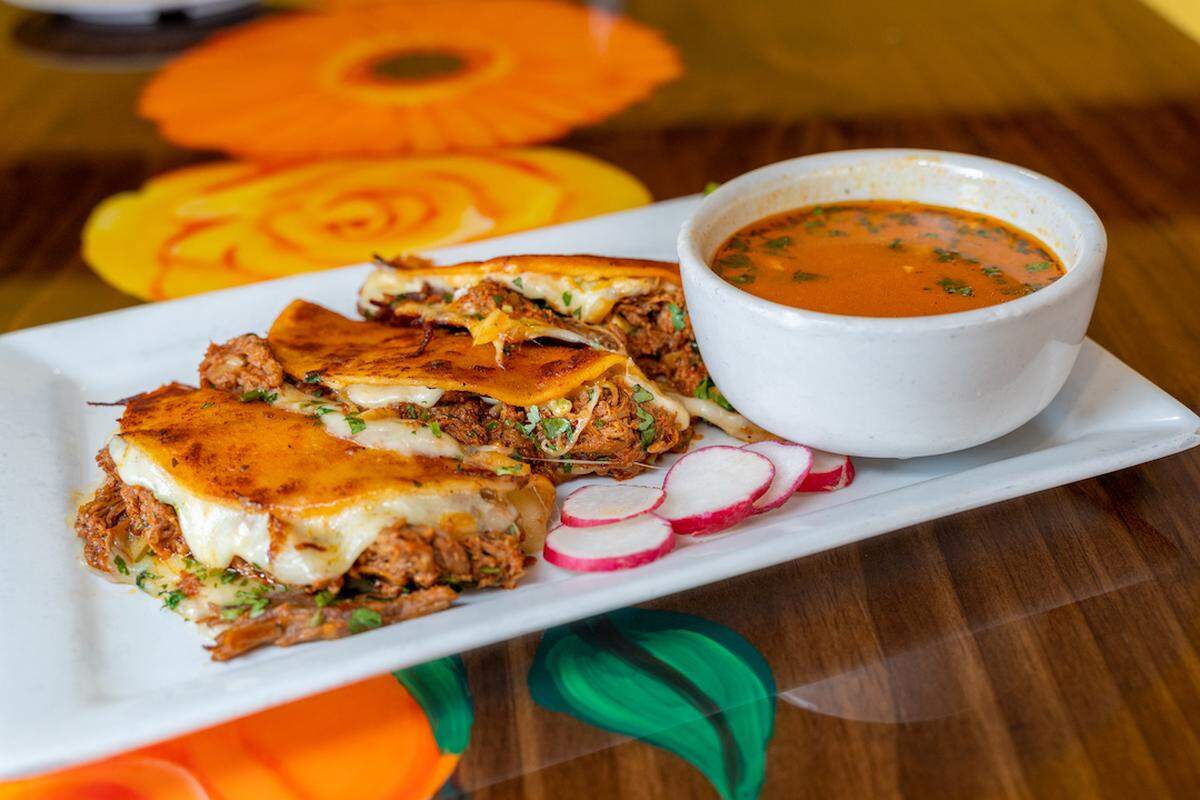 Explore local spots serving TikTok-famous birria tacos.