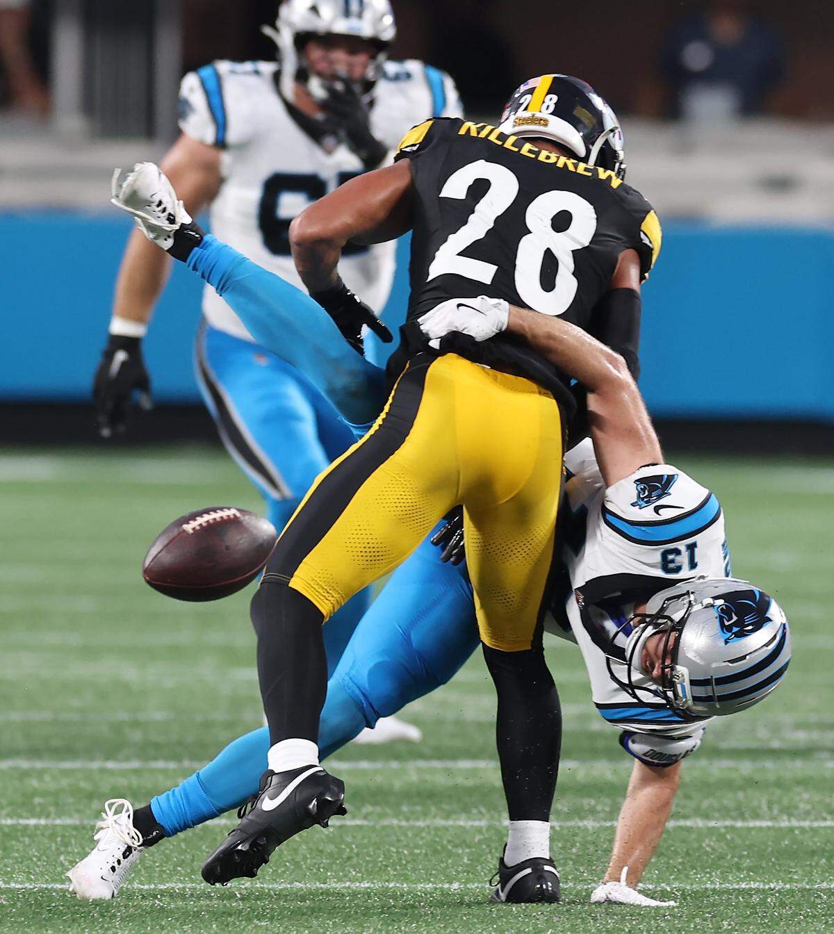Carolina Panthers wide receiver Hunter Renfrow is upended by Pittsburgh Steelers safety Miles Killebrew, back to camera, on a reception attempt at Bank of America Stadium in Charlotte, NC on Thursday, August 21, 2025.