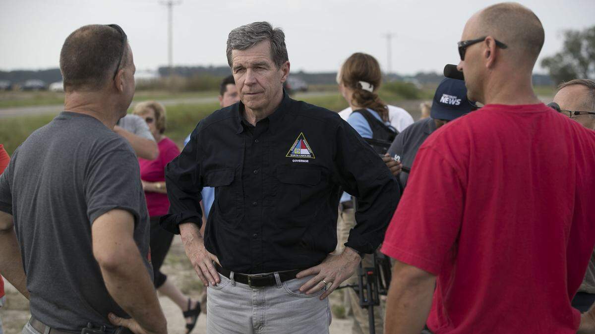 North Carolina Governor Roy Cooper talks with farmers during a visit to Jimmy Burch's farm near Faison, N.C. on Friday, September 21, 2018. Many farmers in the area were hard hit by Hurricane Florence and suffered crop losses. 