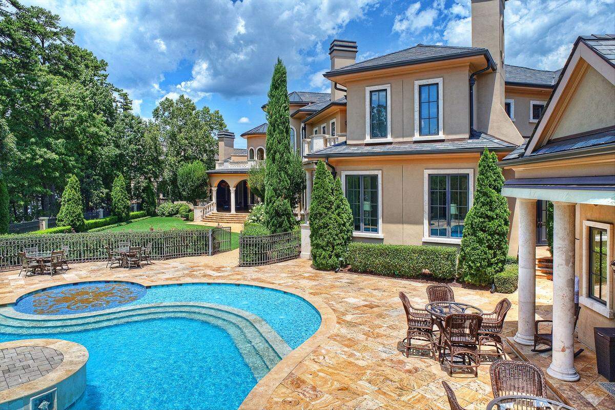 The mansion includes a saltwater pool with glass tile imported from Spain, a spa, fountain, pool house, outdoor kitchen and five-car garage.