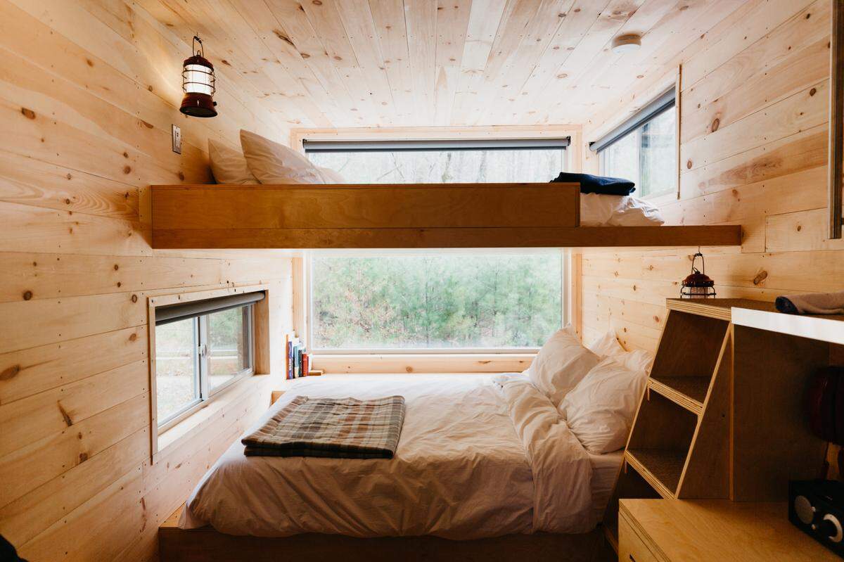 Six cabins at Getaway Asheboro hold queen bunk beds appropriate for three to four guests.