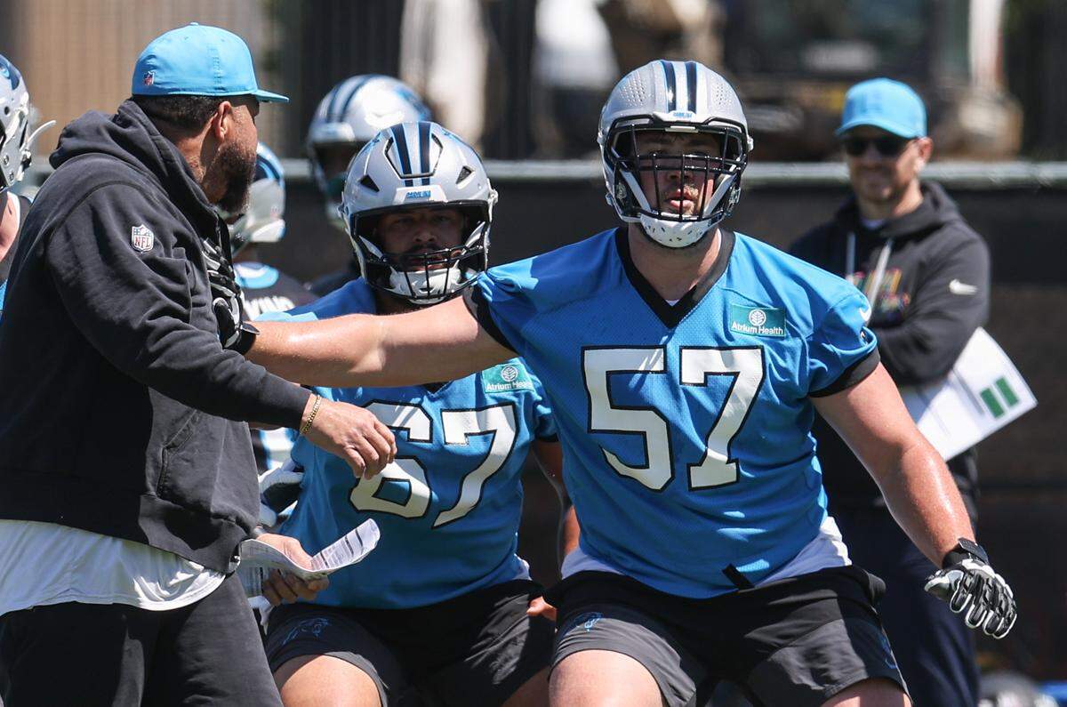 Panthers first-round draft pick Monroe Freeling, right, runs through drills on the first day of rookie minicamp in Charlotte on Friday, May 8, 2026.
