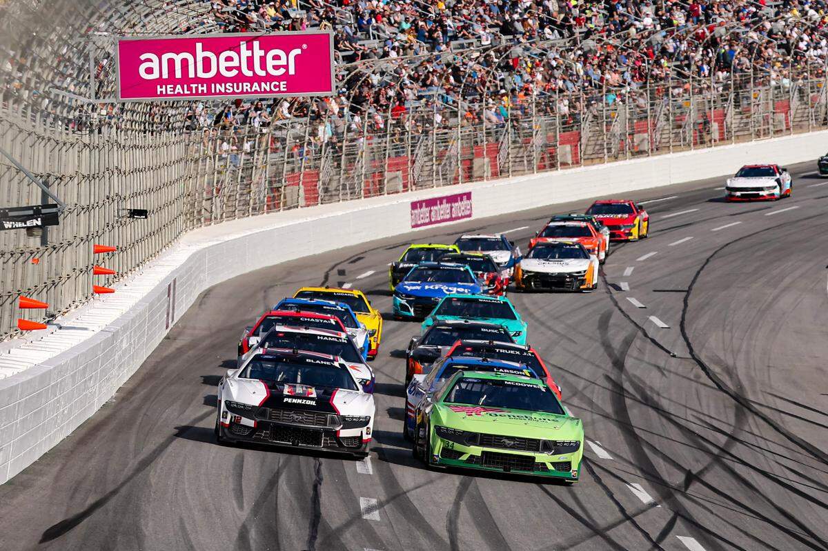 Feb 25, 2024; Hampton, Georgia, USA; NASCAR Cup Series driver Michael McDowell (34) battles with NASCAR Cup Series driver Ryan Blaney (12) during the Ambetter Health 400 at Atlanta Motor Speedway.