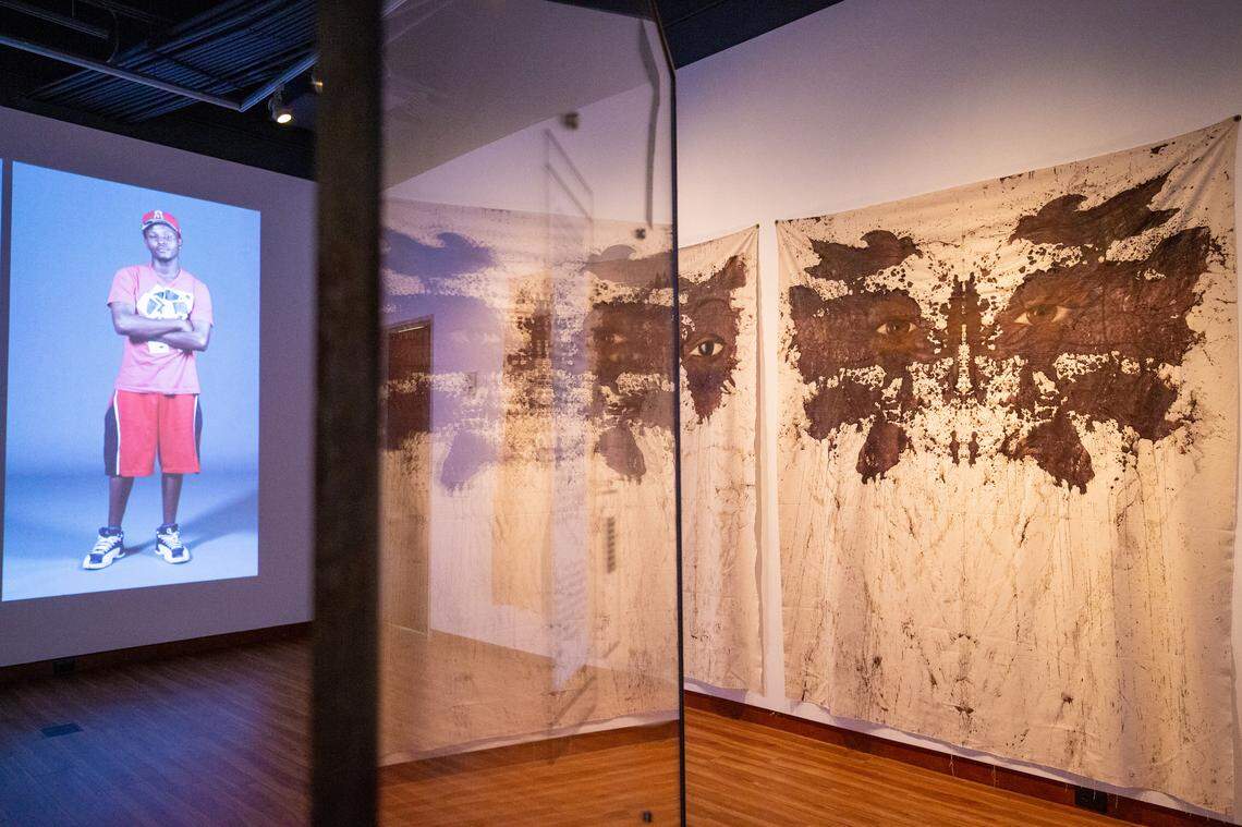 A variety of mediums are used in the “...and justice for all” exhibition, including video installations. Larger than life-sized projections of black men line each end of the gallery and visitors can hear them say aloud how many times in their lives they’ve been stopped by police under the controversial “stop and frisk” policy.