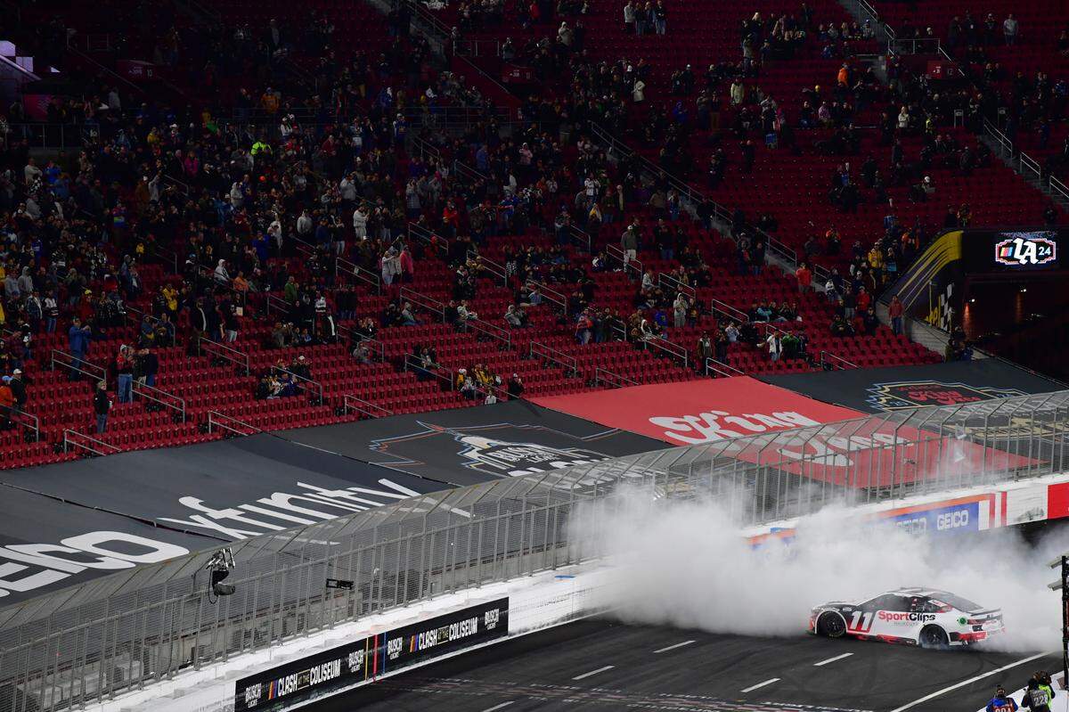 Feb 3, 2024; Los Angeles, California, USA; NASCAR Cup Series driver Denny Hamlin (11) celebrates his victory of the Busch Light Clash at Los Angeles Memorial Coliseum.