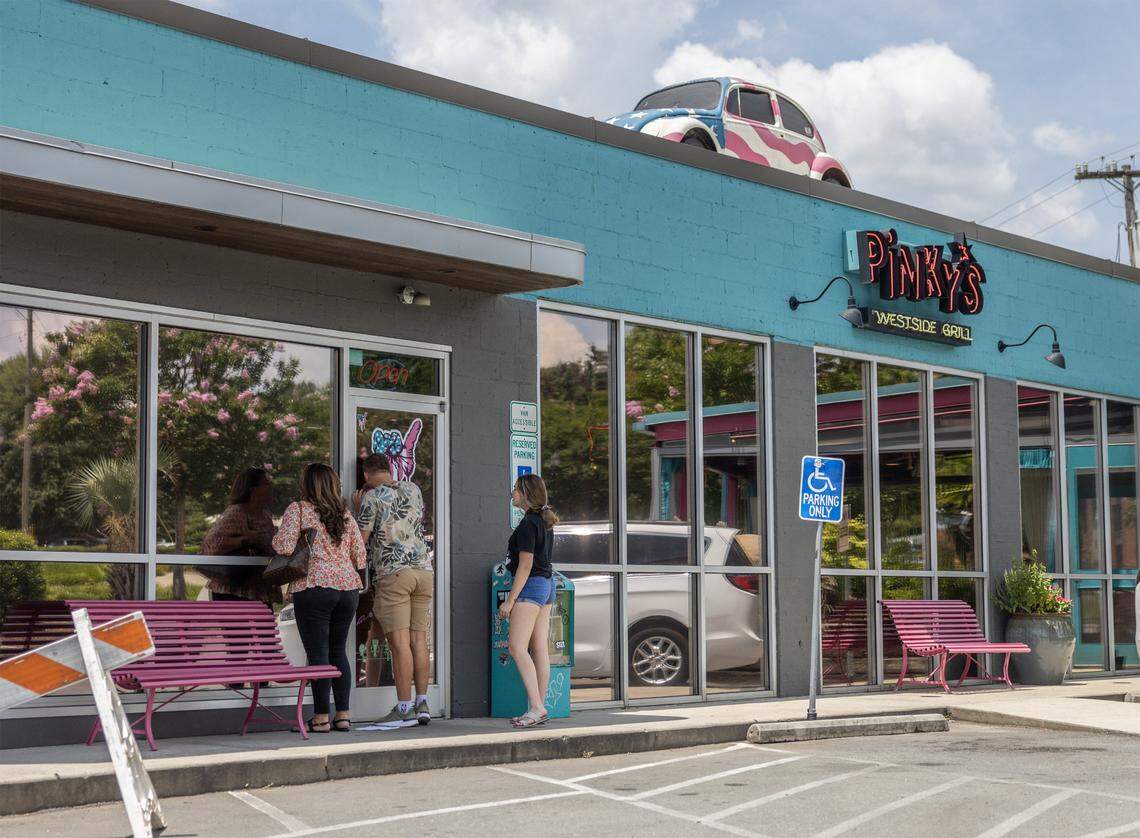 A family peers into the windows at Pinky’s Westside Grill.