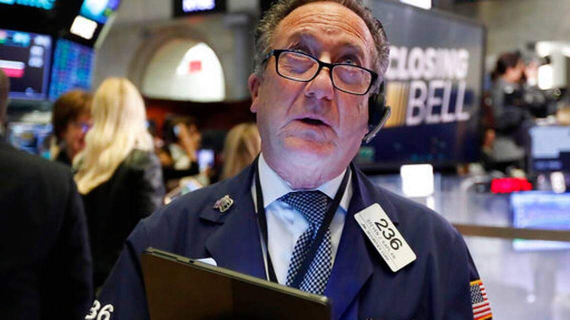 Trader Steven Kaplan watches the numbers at the New York Stock Exchange Monday. Stocks fell sharply Tuesday after a Federal Reserve rate cut failed to stem fears concerning the coronavirus’ impact on the economy.